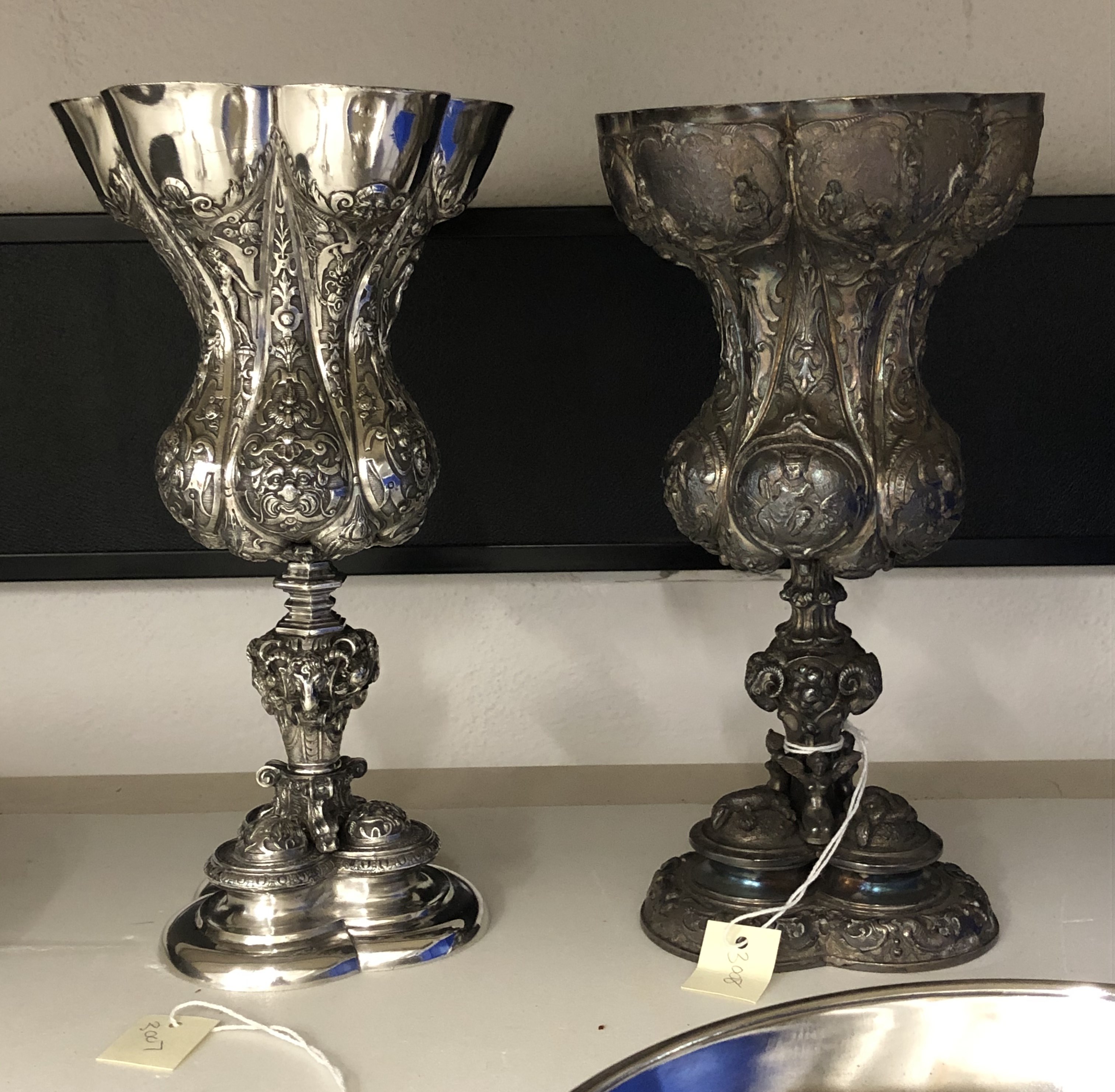 Two metal goblets side by side. The one on the left is polished and silver in colour, while the one on the right is heavily tarnished.